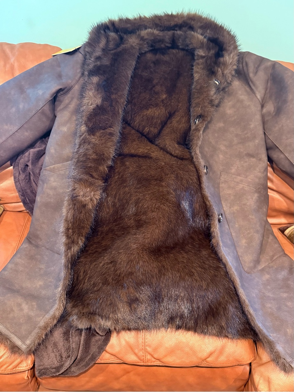 Men’s brown shearling faux fur lined military-style field coat.